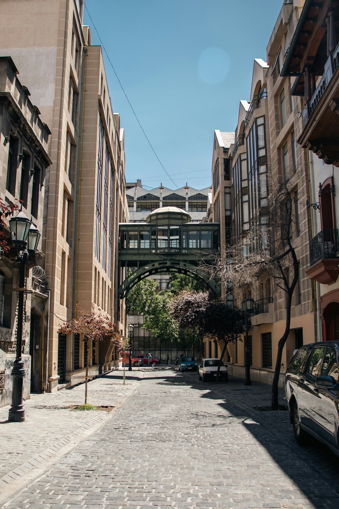 Narrow street in Santiago Chile with colorful houses and a public bus